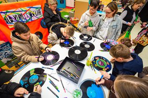A group of children crafting with old records